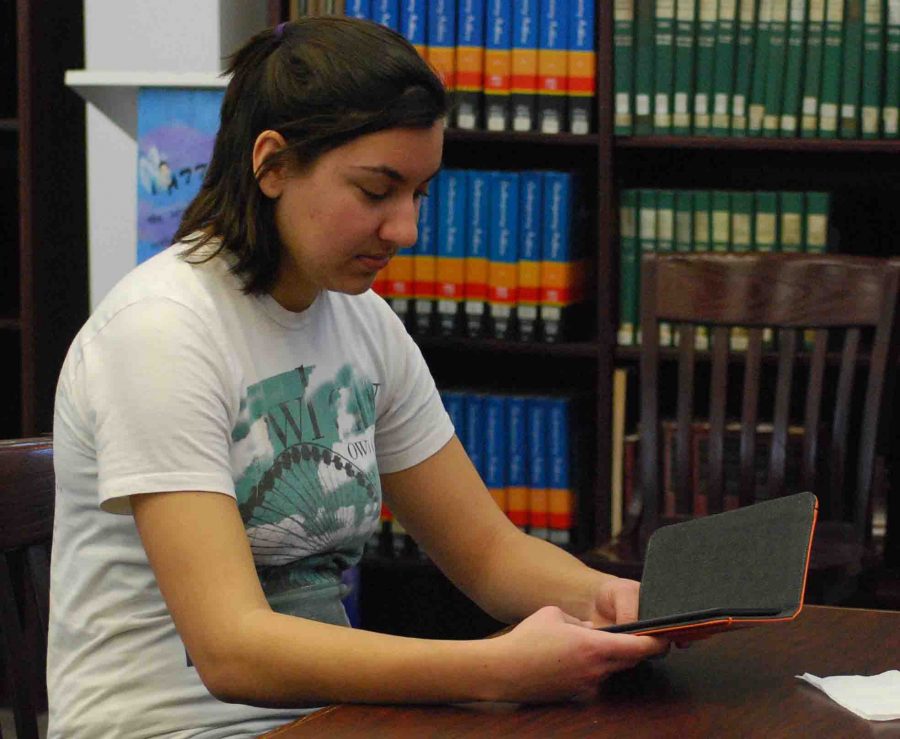 A+student+reads+a+book+from+one+of+the+ten+Amazon+Kindles+in+the+RHS+library.+-photo+by+Nursena+Acar