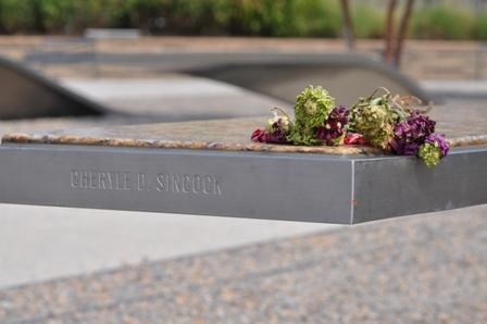 A flower sits atop a bench at the Pentagon Memorial in Arlington, Va. The Memorial is a touching tribute to victims who lost their lives. -- Anne Wagner.