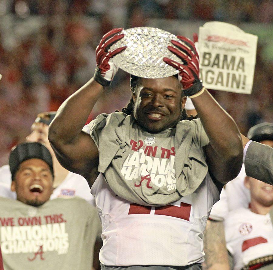 Alabama+running+back+Eddie+Lacy%2C+the+games+MVP%2C+celebrates+with+the+championship+trophy+following+a+42-14+win+against+Notre+Dame+in+the+BCS+National+Championship+game+at+Sun+Life+Stadium+on+Monday%2C+January+7%2C+2013%2C+in+Miami+Gardens%2C+Florida.+Courtesy+of+MCT+Campus