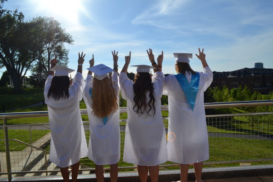 Heavenly+Williams%2C+Torey+Vayer%2C+Adrienne+Tantardini+and+Tess+Garraty+look+off+into+the+distance+while+holding+up+a+one+and+three+to+represent+the+year+they+are+graduating.+--Camila+Torres