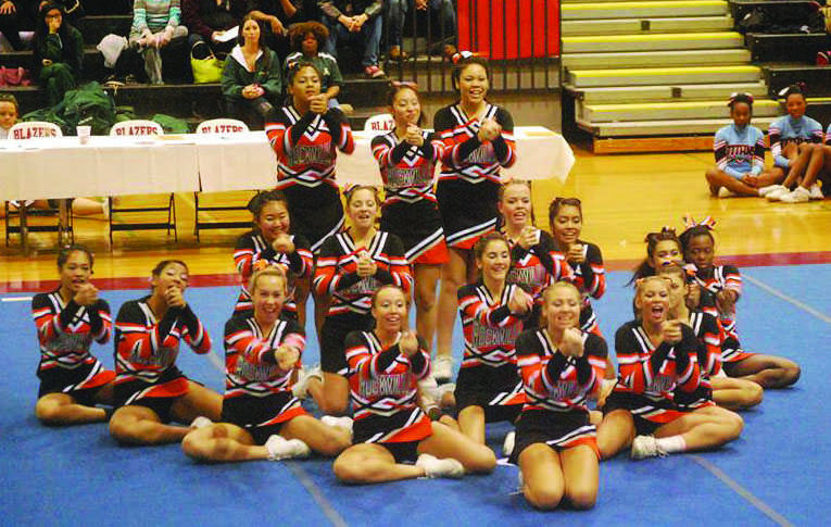 The+Cheerleading+team+shows+the+motions+of+their+routine+at+their+compeition+on+Nov+6.+The+team+placed+fifth+place+out+of+eight+other+teams+in+Division+III.+Courtesy+of+Dorinda+Hailstock