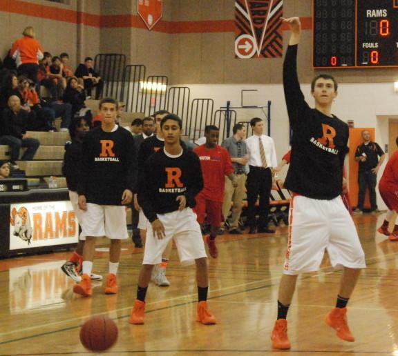 Junior Kellen Cremins sinks a shot as the varsity boys’ basketball team warms up for a game against Wootton HS. The boys won the game by three points. --Mara Monroe