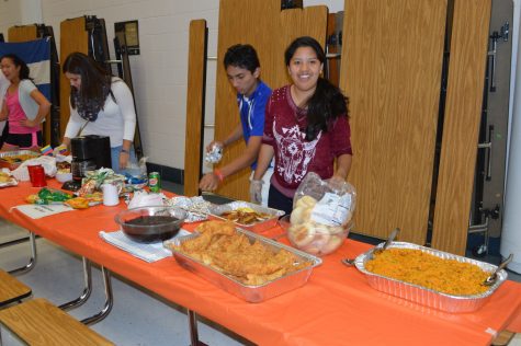 Hispanic club volunteers work together in serving Hispanic food made by different students during Hispanic night.