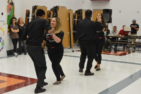 Sophomore Ronald Montevilla, and senior Sylvia Fuentes, members of the Latin dance team, perform a partner dance along with Seniors Alfredo Rivera, and Jennifer Lopez.