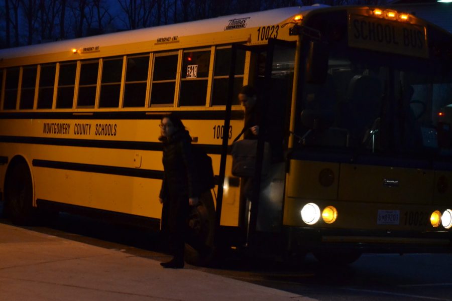 Sophomores Joanna Vigil (left) and Tristan Burch (right) get off of the school bus and head in while it is still dark out. Students have trouble maintaining a healthy amount of sleep every night. --Meklit Bekele
