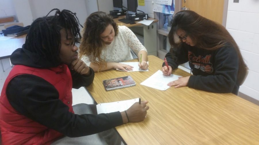 Juniors Dwayne Henry, Liliana Goncalves and Grace Cajayon practice writing college essays, one of the ways that Avid prepares its students for the college application process. --Ronaldo Reyes