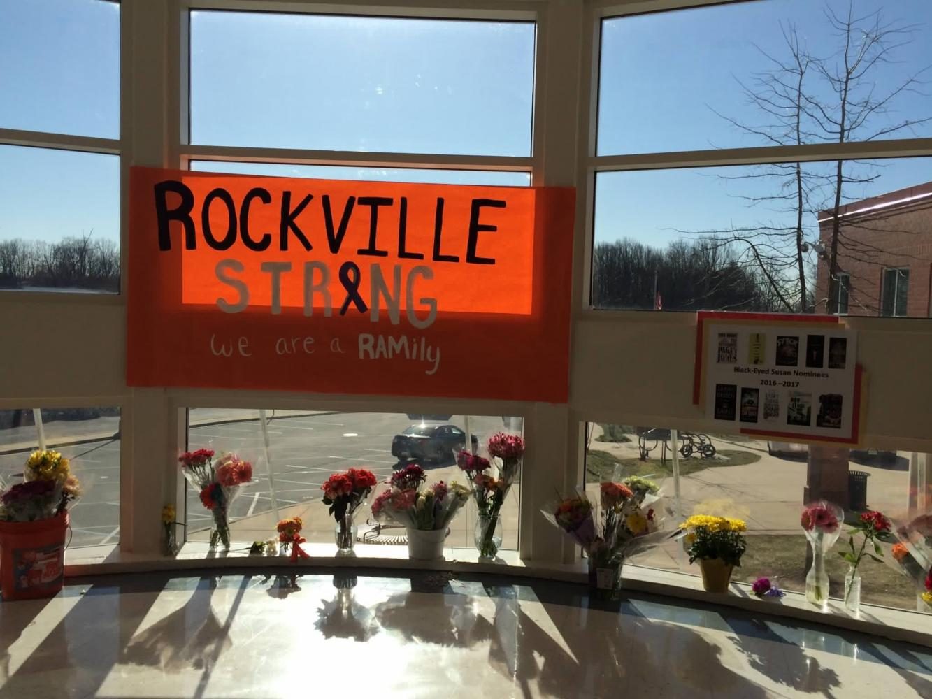 One of the many “Rockville Strong” posters is presented in the Rotunda. Students placed flowers for the victim following the March 16 incident.