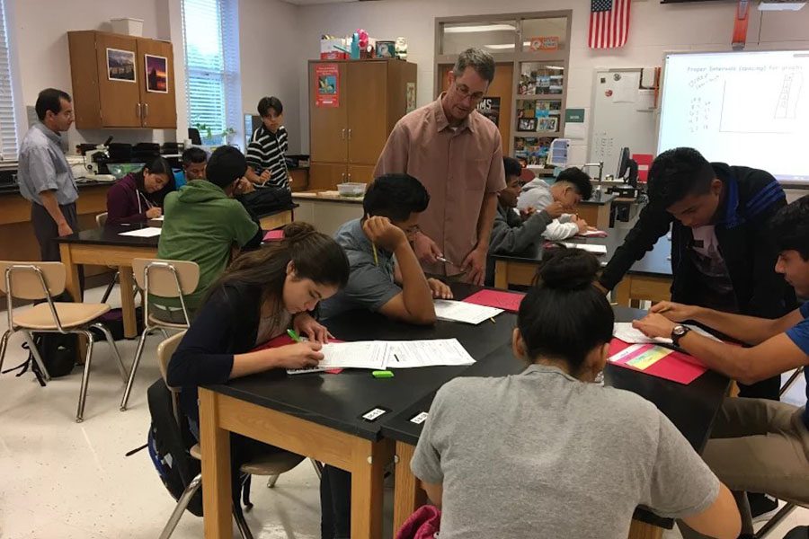 Biology teacher Jeff Grandin works with ESOL students in the new ESOL Biology class.