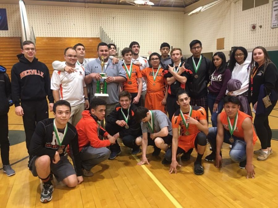Wrestling team poses for a photo with awards after their win at Parkside high school.  