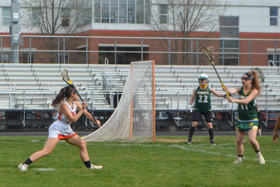 Senior captain Julie Gage passes the ball toward the net in Damascus HS’ defensive zone.