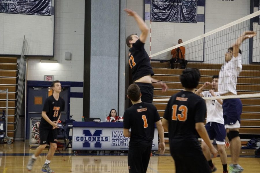 Senior Thomas Rada rises above the net for a kill. 