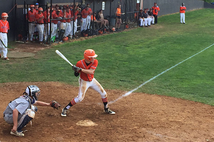 Junior Matt McTighe winds up to swing at incoming pitch during the sectional finals. McTighe was the starting pitcher for RHS, lasting three innings.