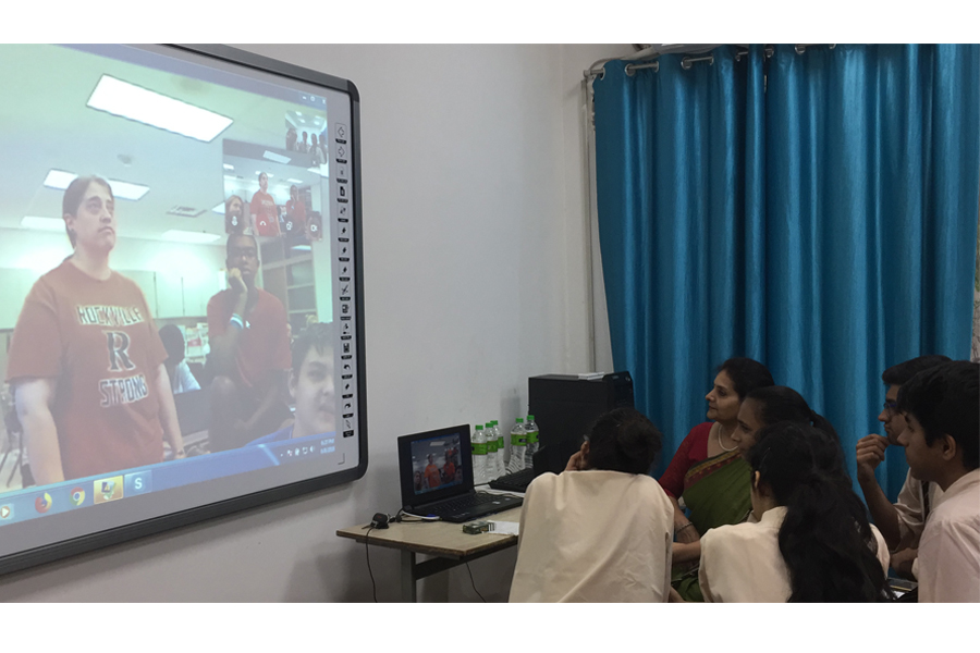 Sixteen-year-old students in India Skype call with students in history teacher Rene Shuler's NSL class.