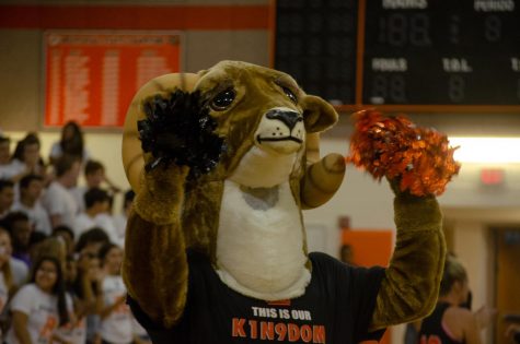 Rammy cheers for the fall athletes as they run out onto the court.