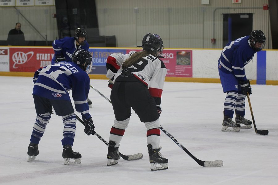 Sophomore Evelyn Leighton (center) skates against the Sherwood Warriors Nov. 7.  She joined varsity this year after playing for JV as a freshman.