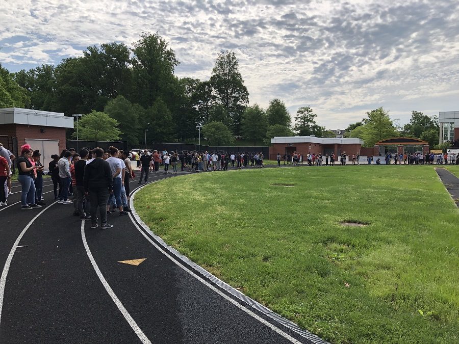 Students lined the track in Joseph B. Good Stadium after being evacuated by a fire alarm due to a burst sprinkler May 30.