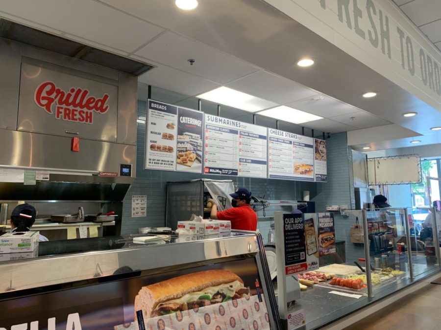 The menu, ordering area, and kitchen of Jersey Mike's is modern and inviting. The fresh bread pulled out by employees contributed to the overall high rating of the sub. 