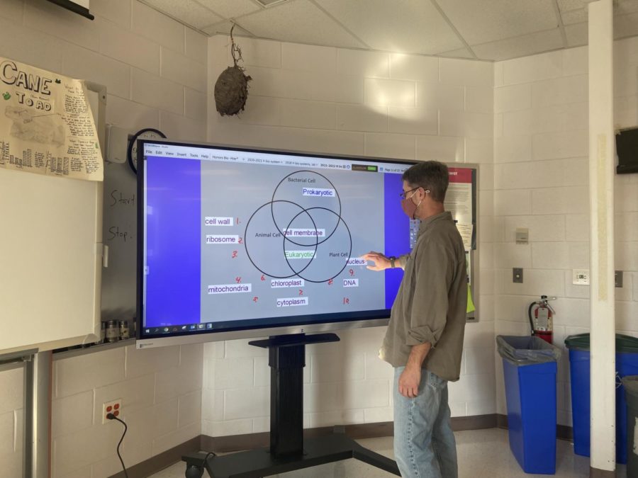 Biology teacher Mr. Grandin uses the touch screen features of the new BoxLight in his classroom to help students visualize course content.