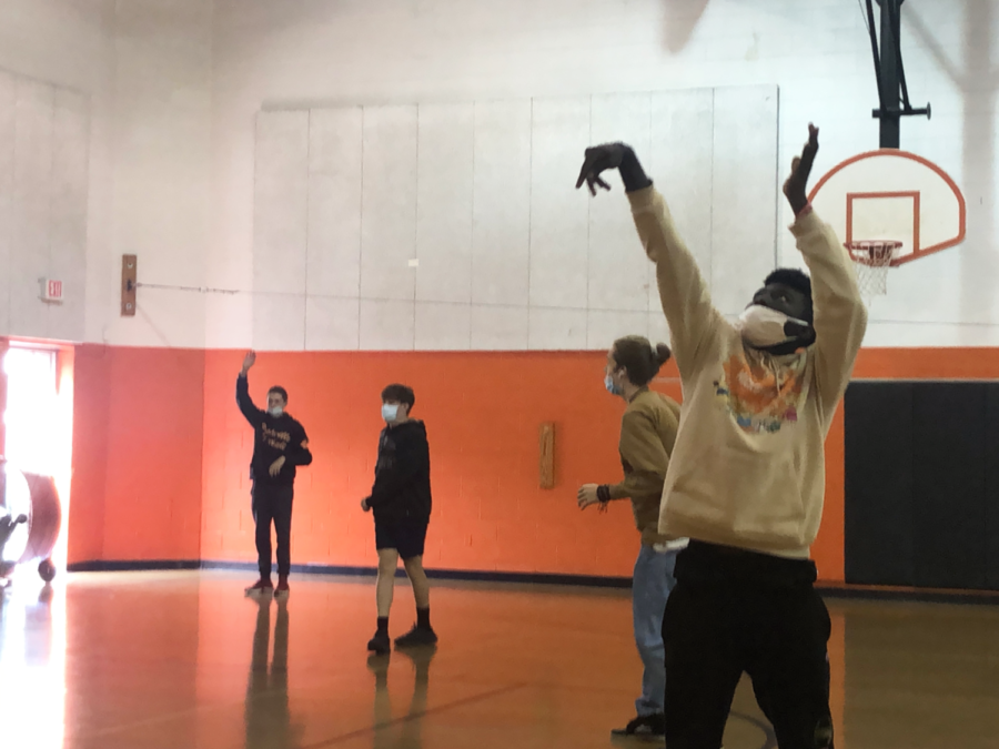 Students play basketball during the school day while wearing masks at all times. Stringent COVID-19 protocols are expected to continue as sports move indoors for the winter.