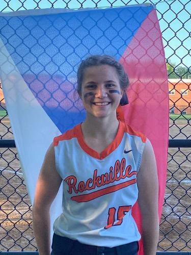 Junior Hana Žitňanská poses in front of a Czech Republic flag while in her RHS softball uniform. 