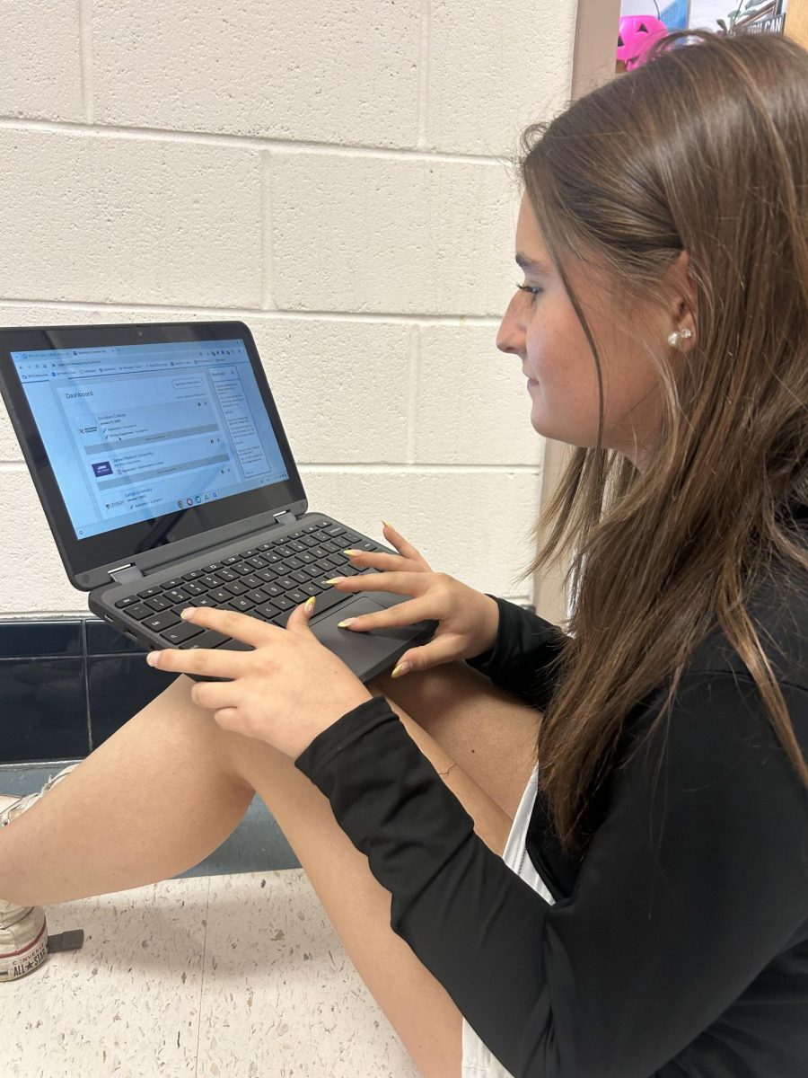 Senior Erin Kelly works on her Common App in the RHS hallway in her spare time.