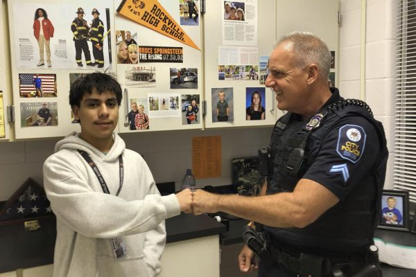 Cpl. Steven Pascali fistbumps a student at Rockville High School